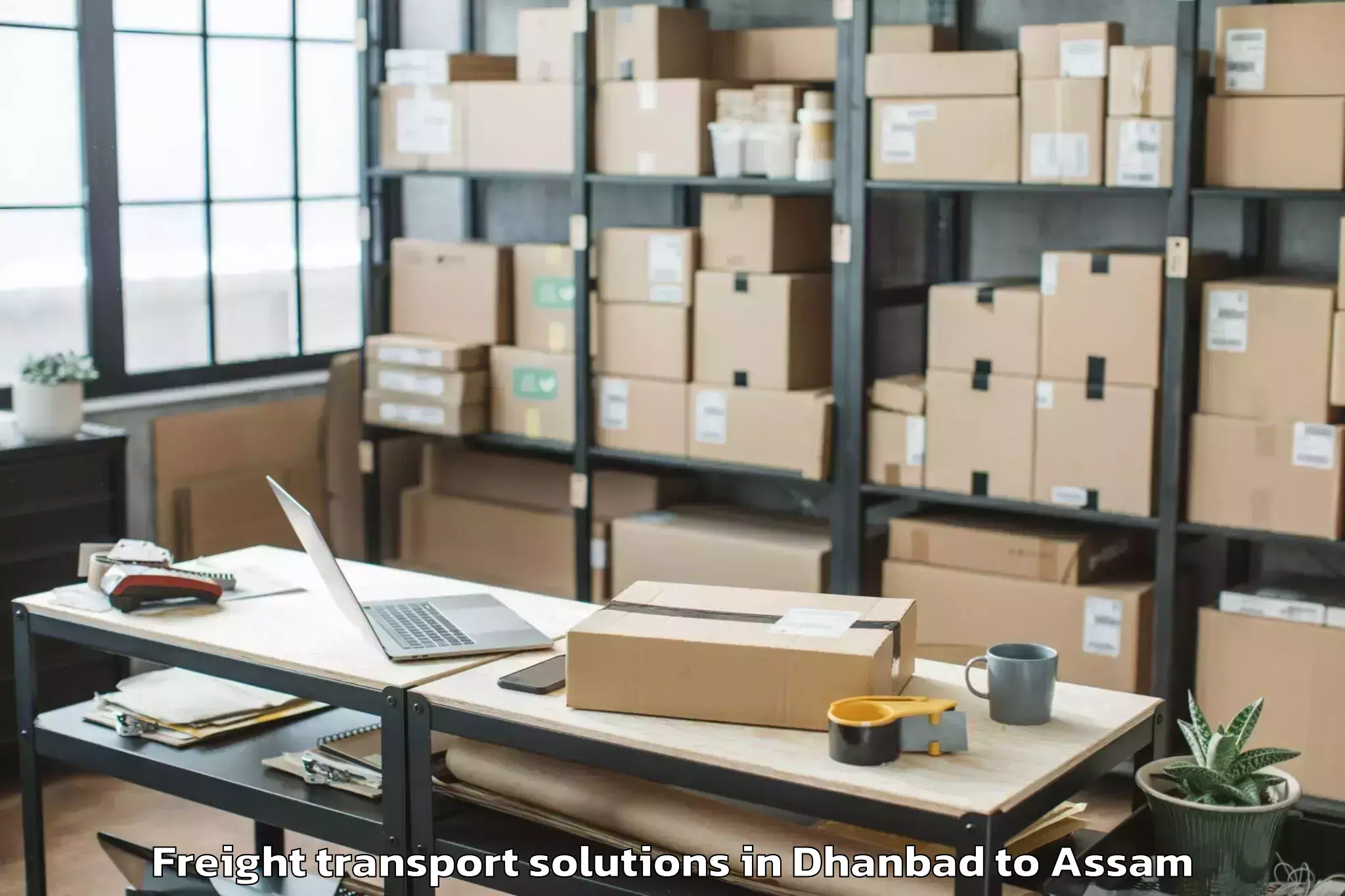 Easy Dhanbad to Darangamela Freight Transport Solutions Booking